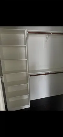 a view of walk in closet with empty racks