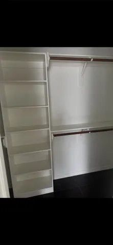 a view of walk in closet with empty racks
