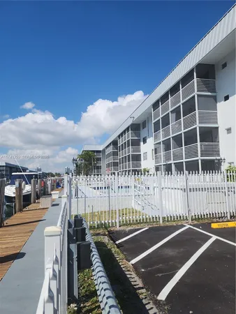 a view of a balcony with a large window and wooden fence