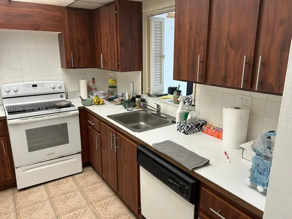 a kitchen with a sink stove and cabinets