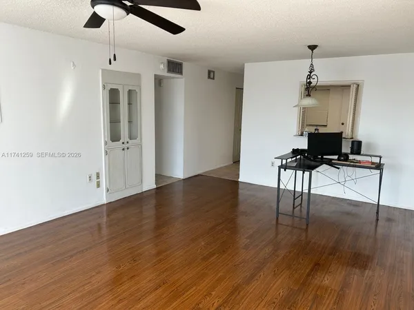 a view of a workspace with wooden floor