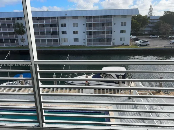 a view of a refrigerator with wooden floor and windows