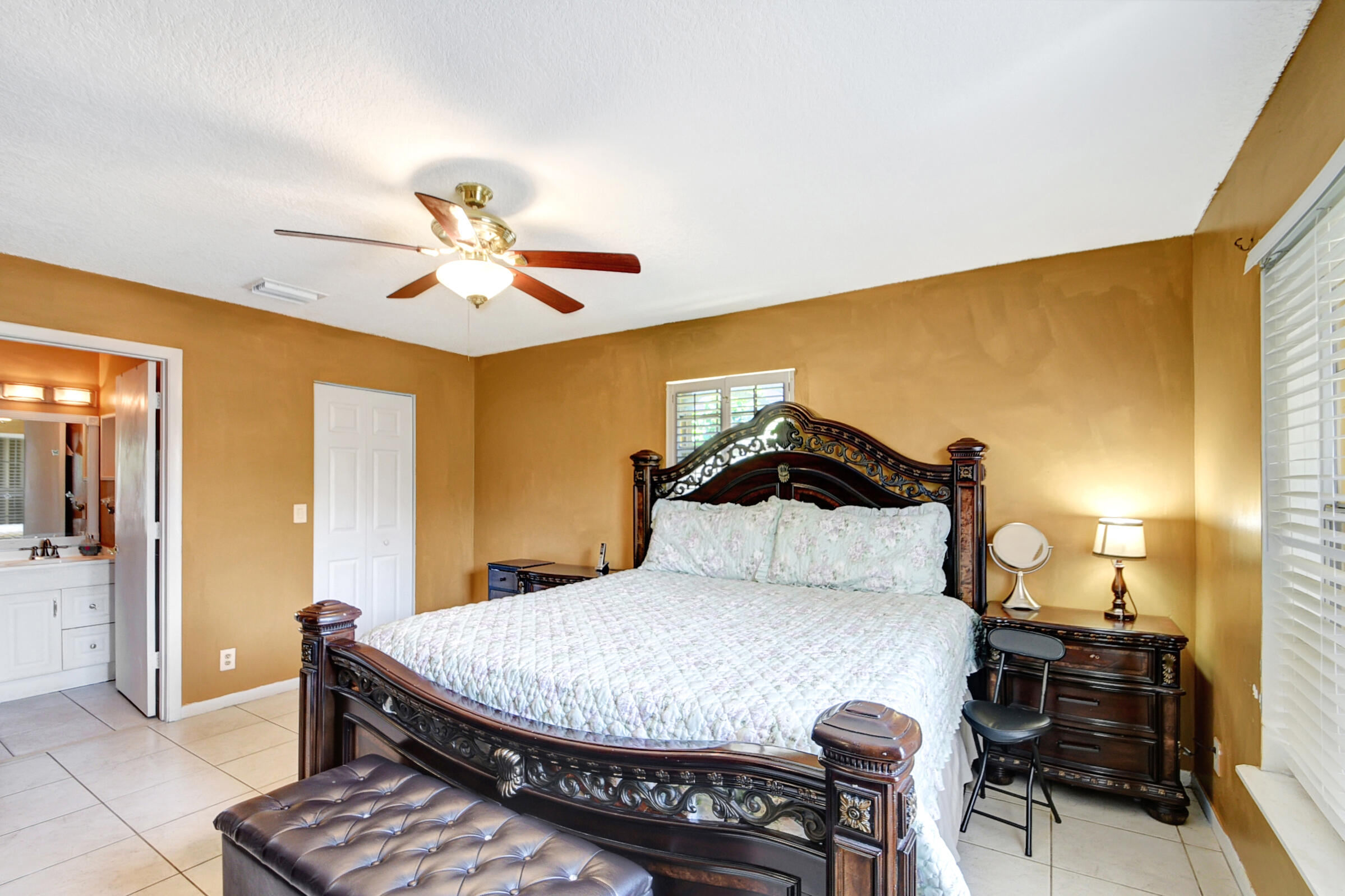 10128 Boynton Pl Circle Boynton Beach, FL 33437 - Photo 12 of 25 a bedroom with a bed and a chandelier