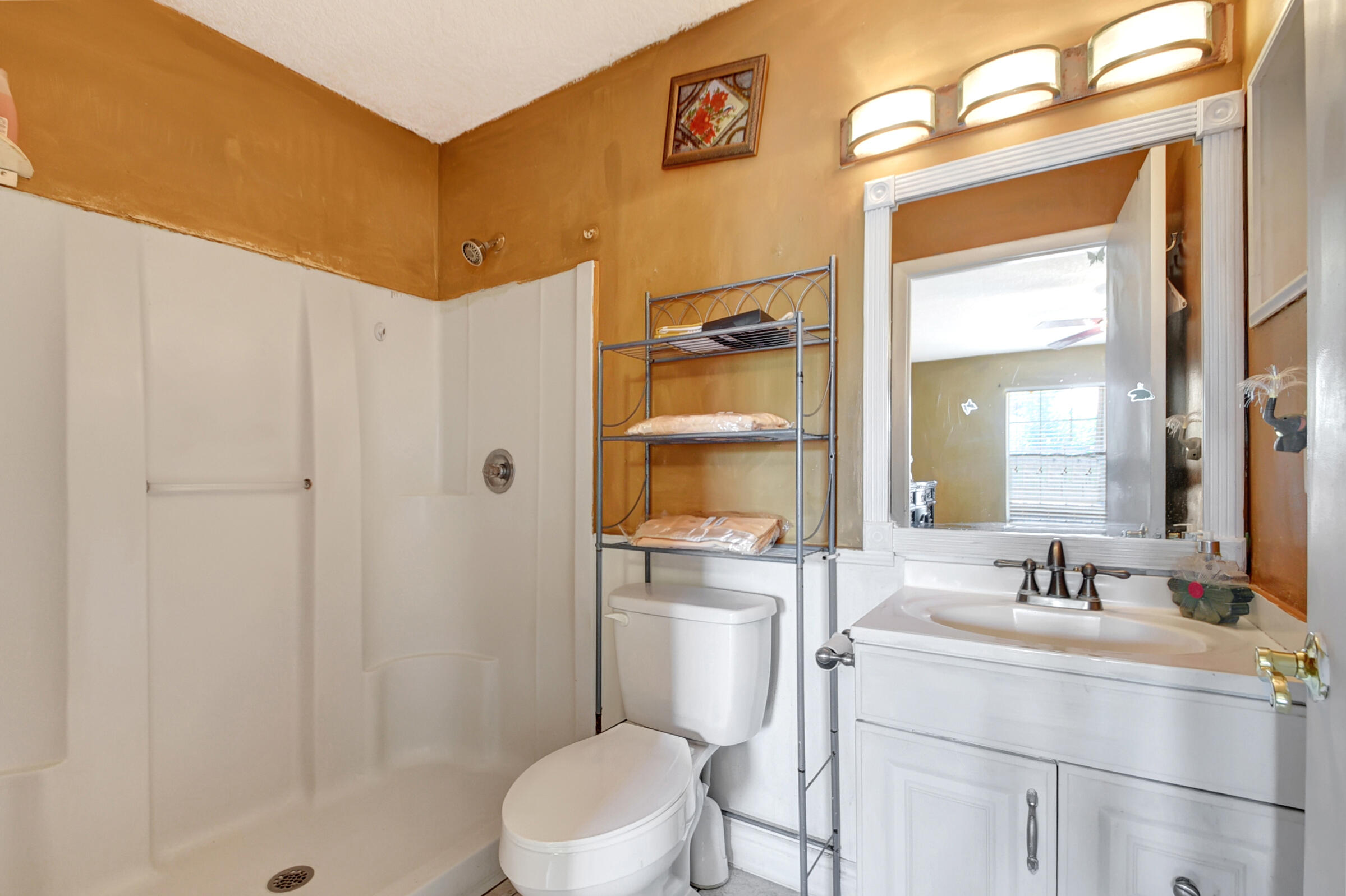 10128 Boynton Pl Circle Boynton Beach, FL 33437 - Photo 13 of 25 a bathroom with a sink a toilet and shower