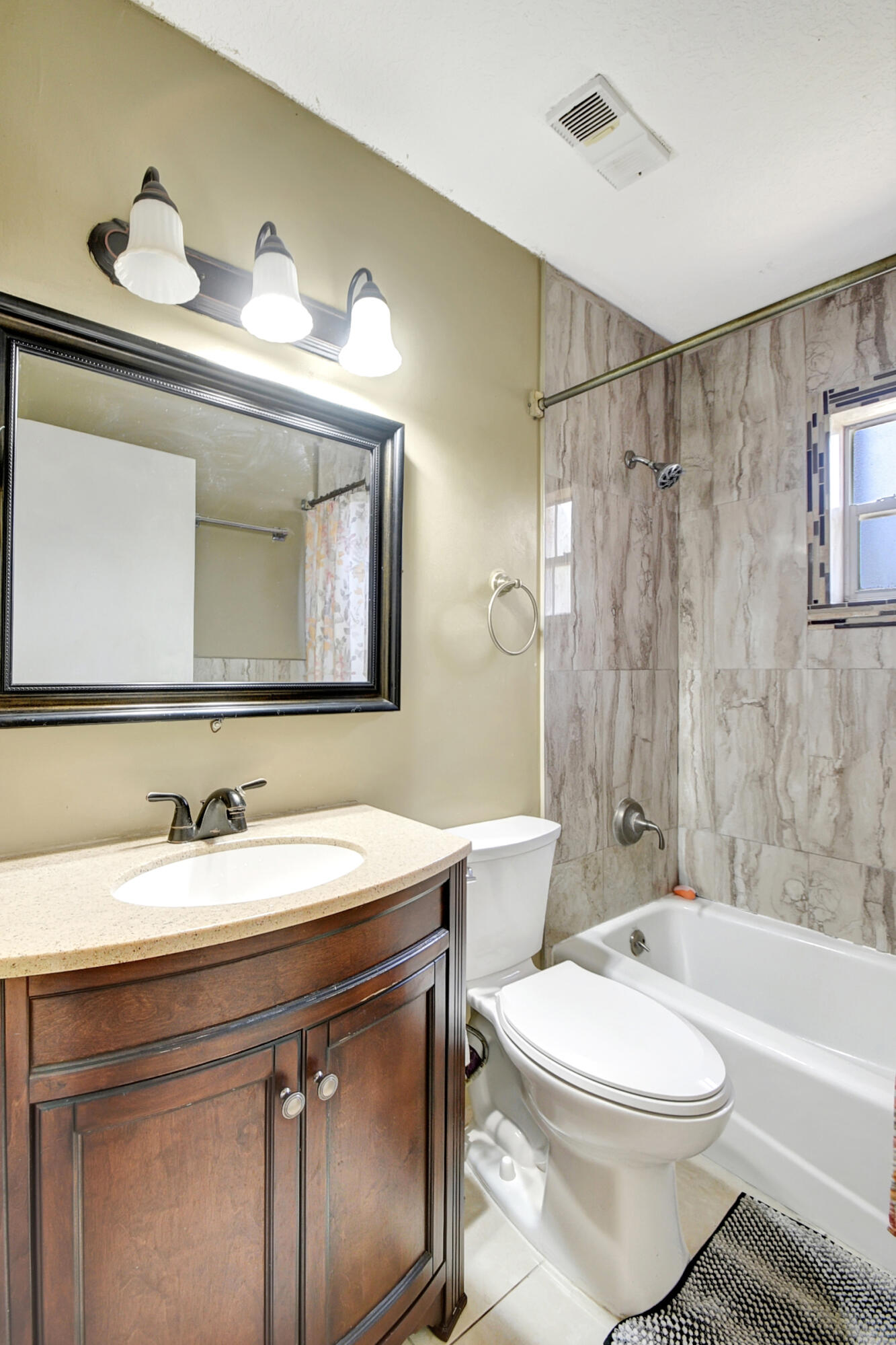 10128 Boynton Pl Circle Boynton Beach, FL 33437 - Photo 17 of 25 a bathroom with a toilet a sink a tub and mirror