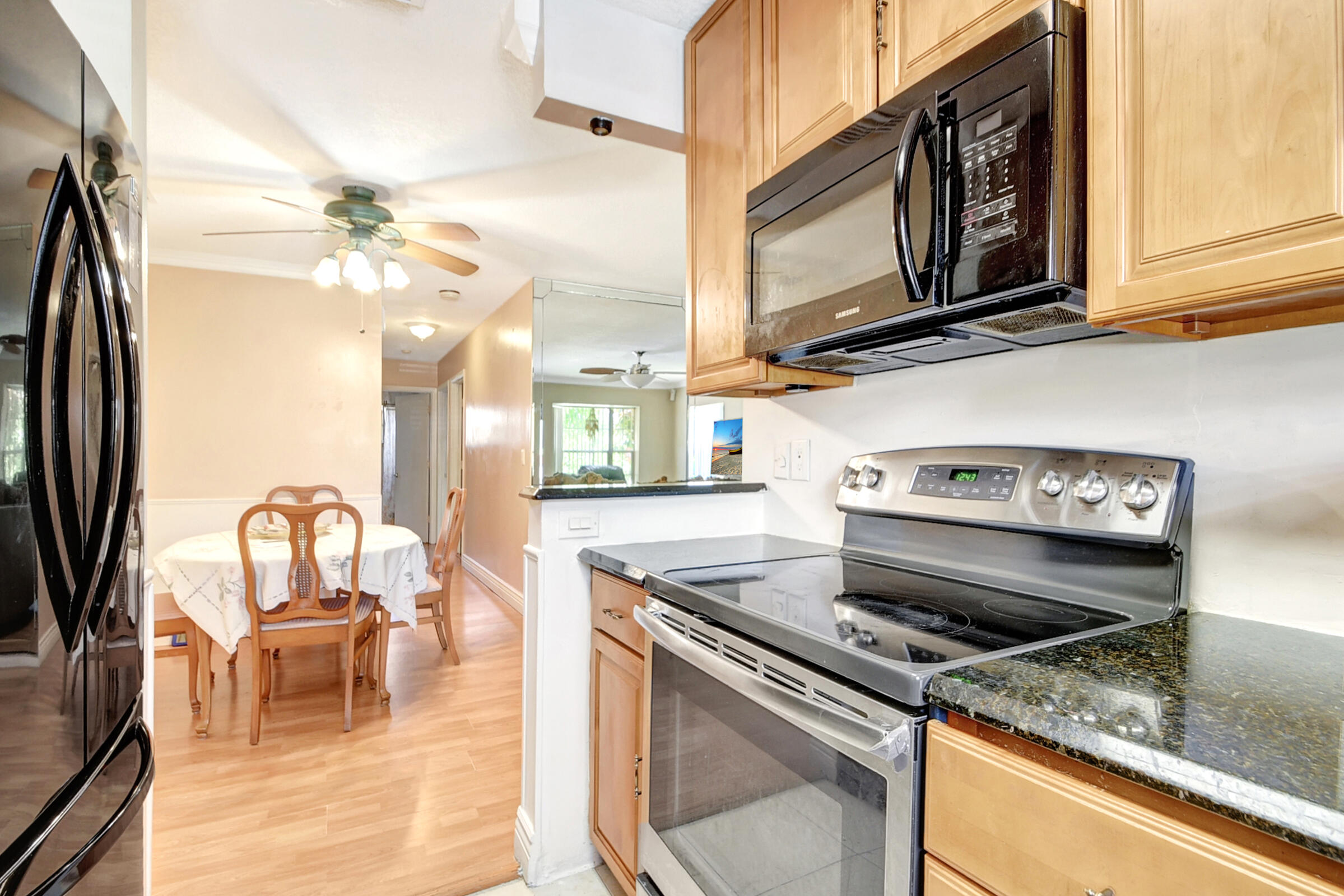 10128 Boynton Pl Circle Boynton Beach, FL 33437 - Photo 7 of 25 a kitchen with a stove a fireplace and a counter top space