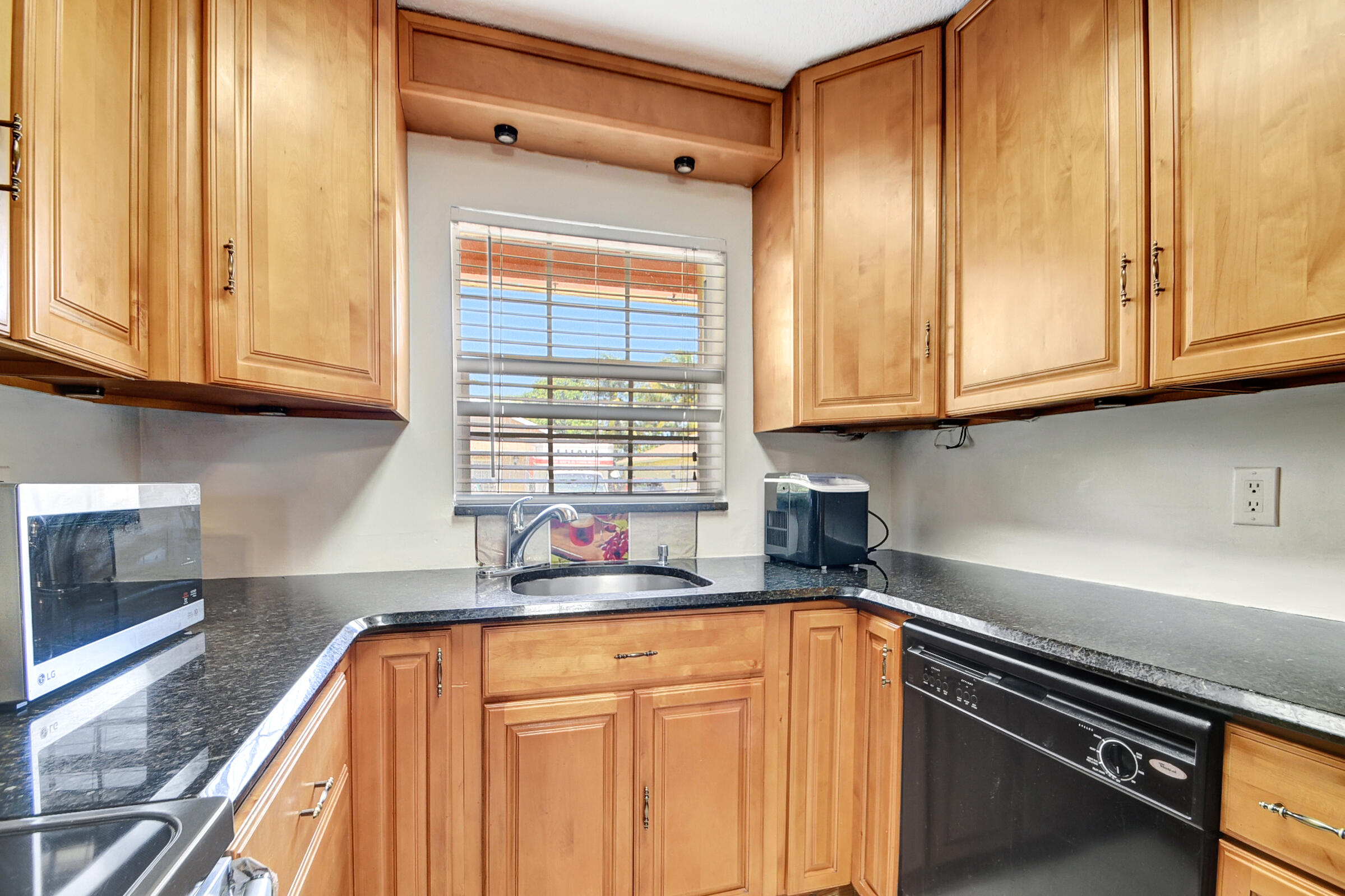 10128 Boynton Pl Circle Boynton Beach, FL 33437 - Photo 9 of 25 a kitchen with stainless steel appliances granite countertop a refrigerator and a sink