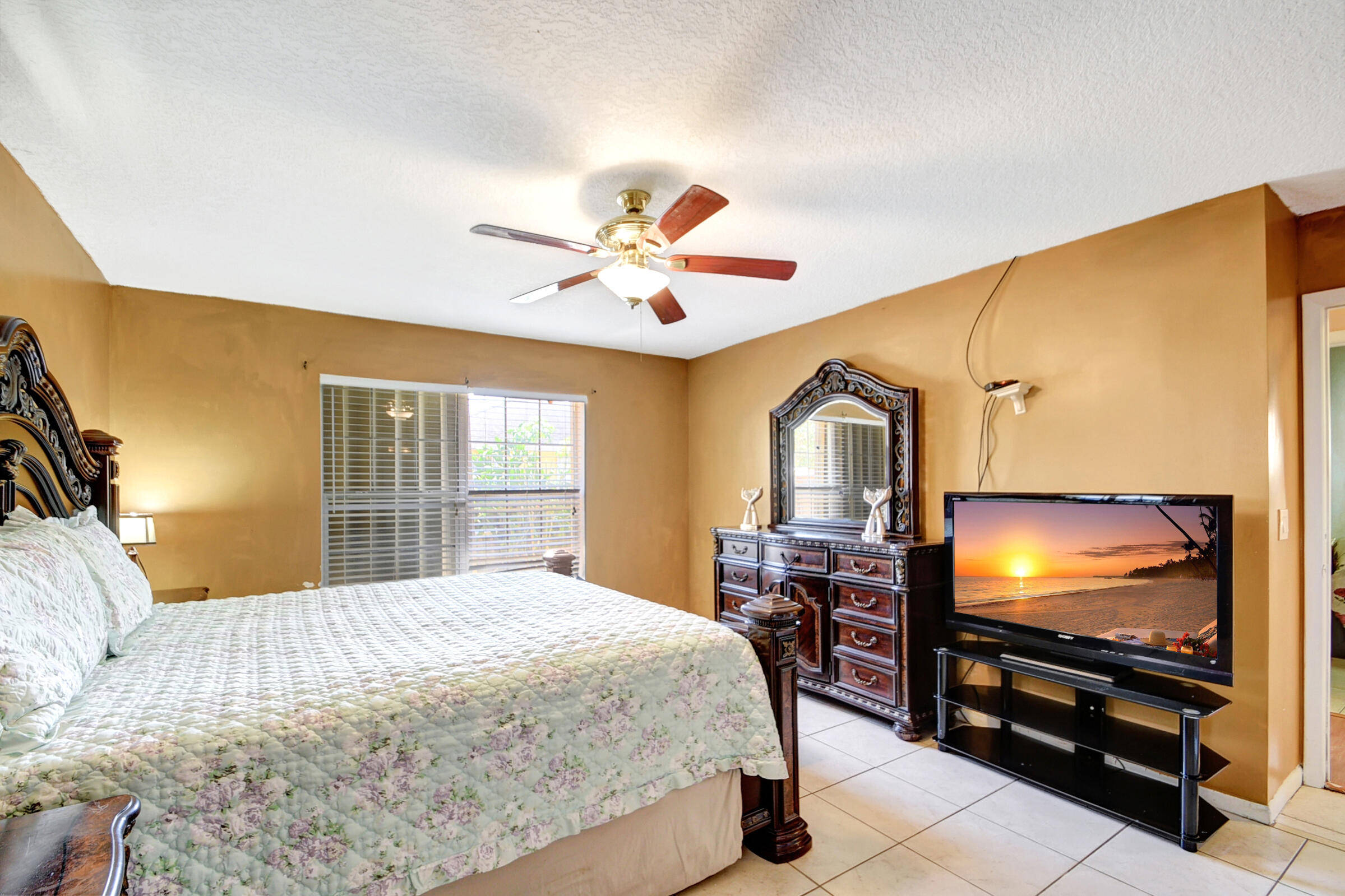 10128 Boynton Pl Circle Boynton Beach, FL 33437 - Photo 10 of 25 a bedroom with a bed and a flat screen tv