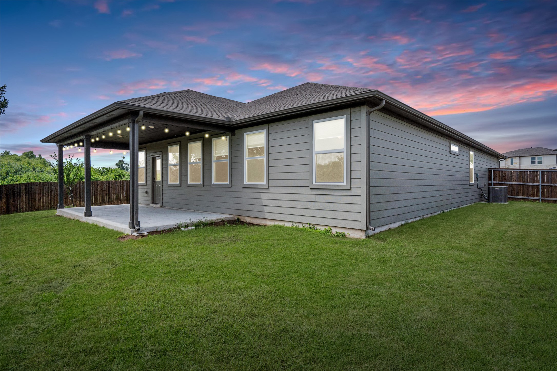 104 Stinchcomb Road Hutto, TX 78634 - Photo 34 of 40 Step outside to enjoy a large covered patio, fruit trees, an oversized backyard, and a peaceful greenbelt backdrop that makes the outdoor space feel both private and rare.