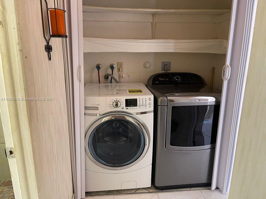 6449 Pinehurst Circle, Unit C25 Tamarac, FL 33321 - Photo 12 of 22 a utility room with dryer and washer