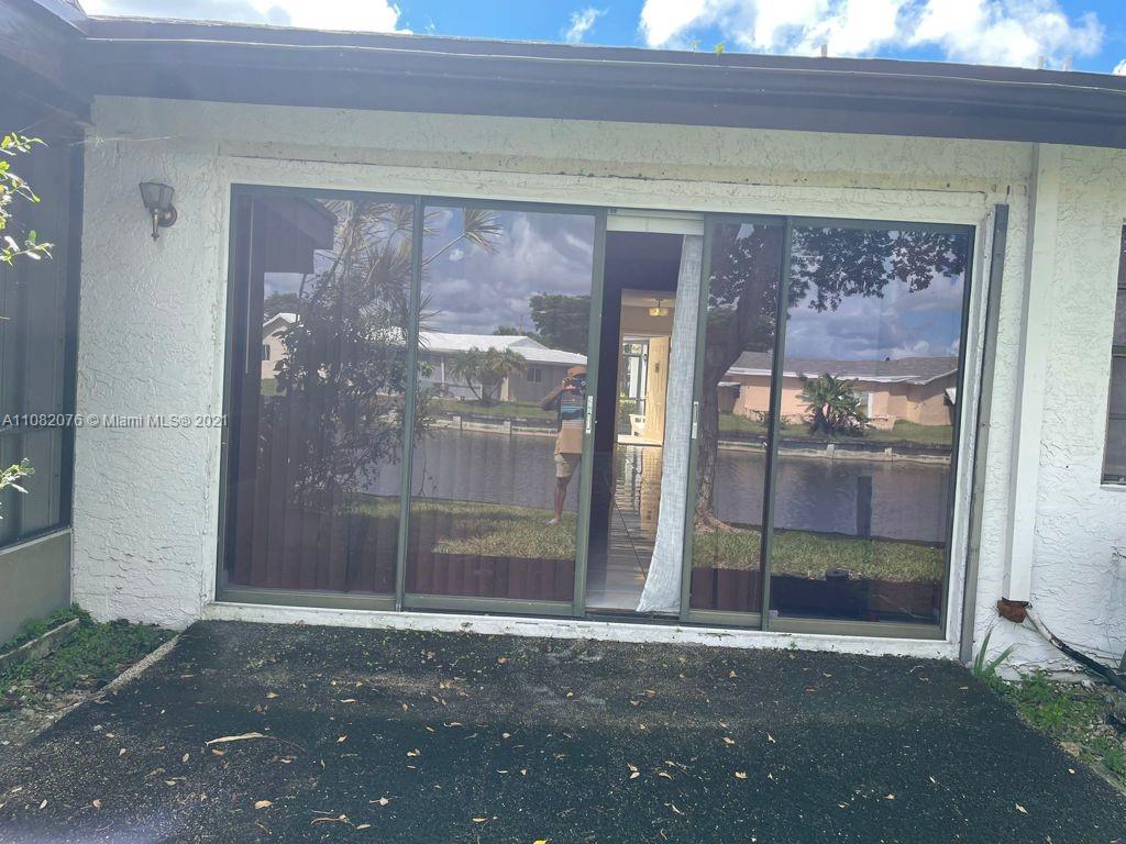 6449 Pinehurst Circle, Unit C25 Tamarac, FL 33321 - Photo 17 of 22 a view of a glass door with a glass door