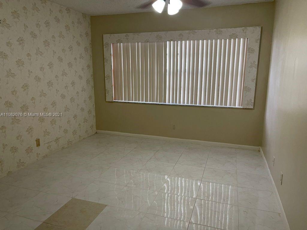 6449 Pinehurst Circle, Unit C25 Tamarac, FL 33321 - Photo 19 of 22 an empty room with a window