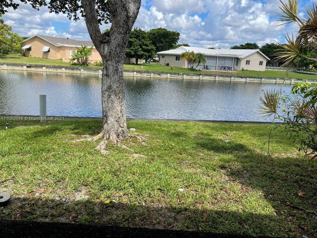 6449 Pinehurst Circle, Unit C25 Tamarac, FL 33321 - Photo 20 of 22 a view of a house with a yard