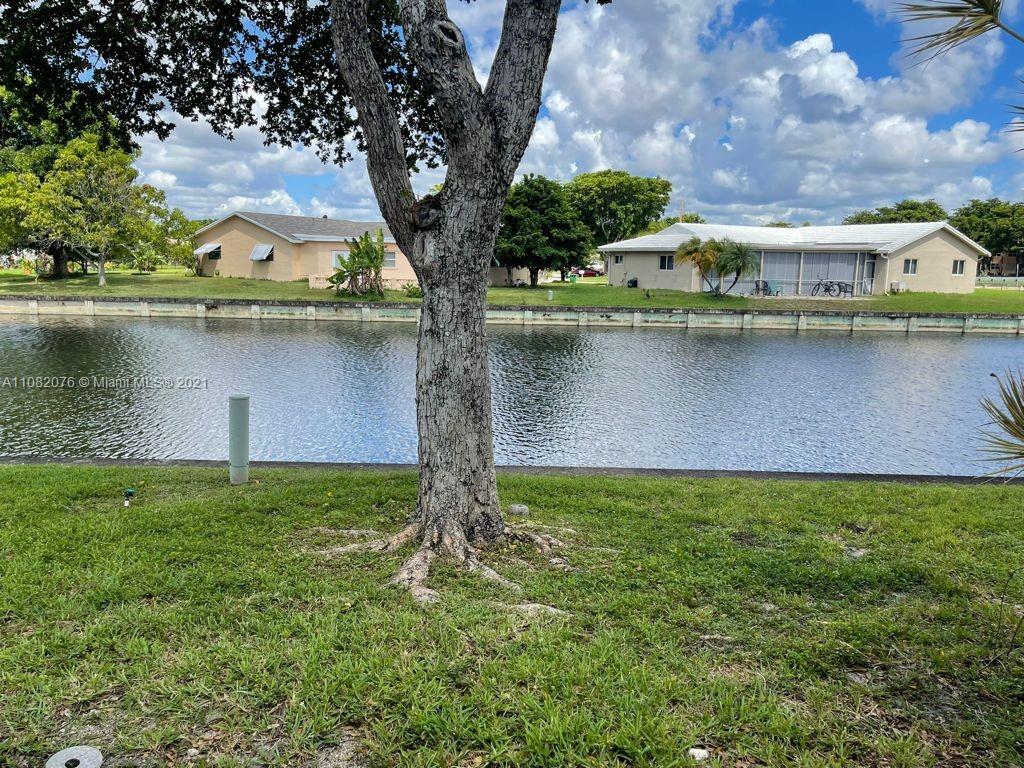 6449 Pinehurst Circle, Unit C25 Tamarac, FL 33321 - Photo 21 of 22 a view of a lake with a large trees