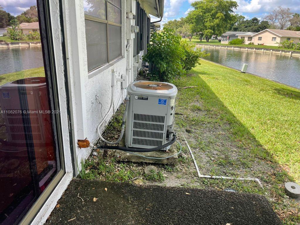 6449 Pinehurst Circle, Unit C25 Tamarac, FL 33321 - Photo 22 of 22 a backyard of a house with a yard and outdoor seating