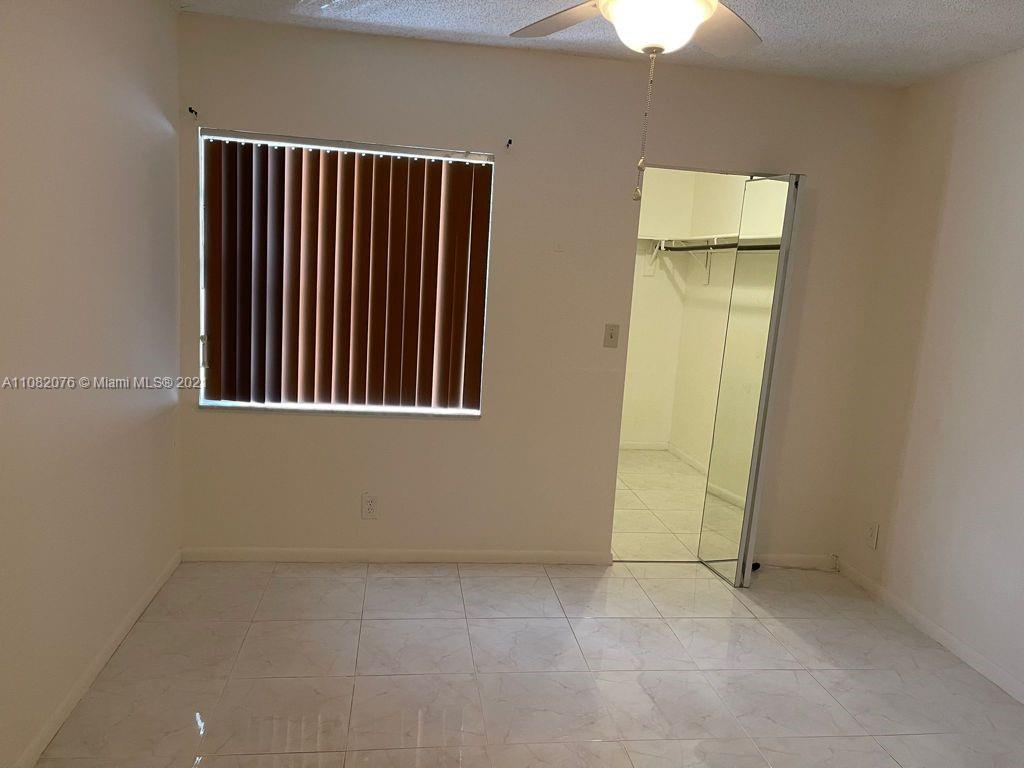 6449 Pinehurst Circle, Unit C25 Tamarac, FL 33321 - Photo 5 of 22 an empty room with windows