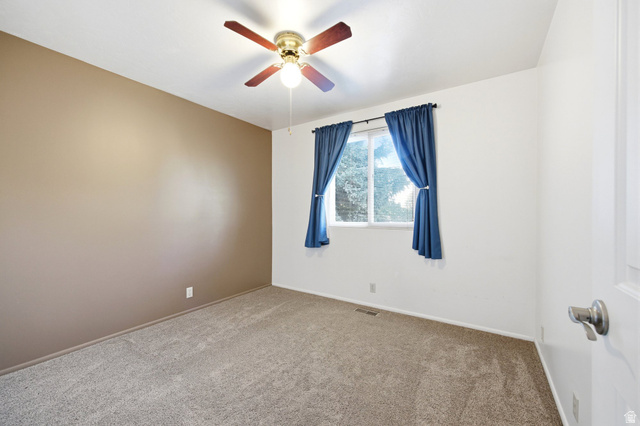 734 Sandy Dunes Drive Sandy, UT 84094 - Photo 20 of 36 Upstairs 2nd Bedroom featuring a dual-pane window, ceiling fan with integrated lighting, and neutral-toned carpeting