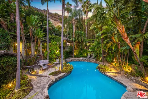 a view of a porch with furniture and a potted plant
