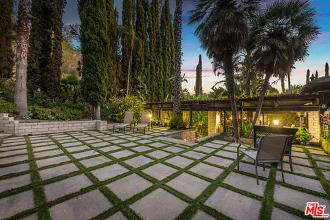 a view of swimming pool with outdoor seating and a potted plant