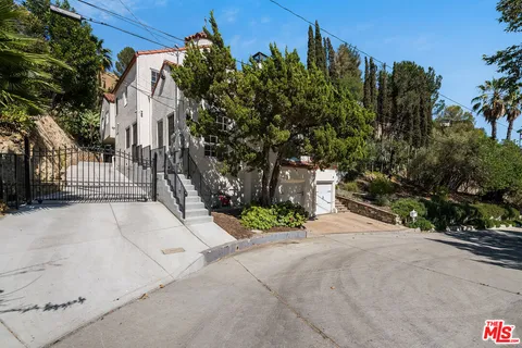 a living room with furniture a fireplace and a large window
