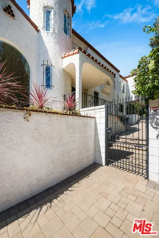 a dining room with furniture a chandelier and wooden floor