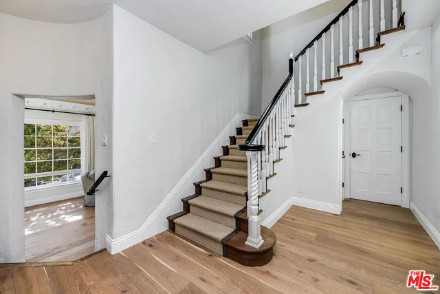 a kitchen with granite countertop cabinets stainless steel appliances and wooden floor