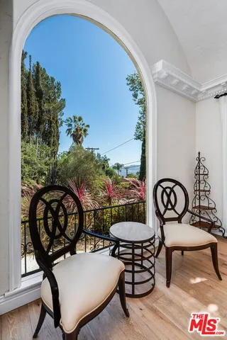 a kitchen with stainless steel appliances kitchen island granite countertop a sink counter space and two windows