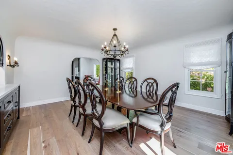 a bathroom with a granite countertop toilet a sink and a mirror