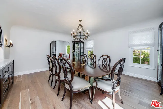 a bathroom with a granite countertop toilet a sink and a mirror