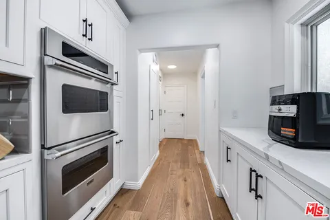 a bed room with a bed mirror and a window
