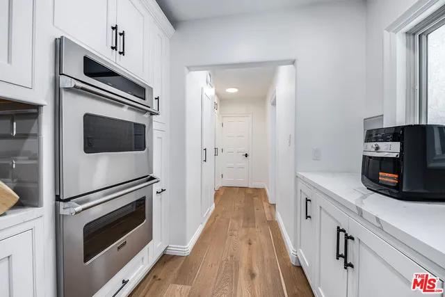 a bed room with a bed mirror and a window