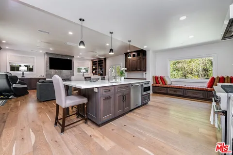 a bed sitting in a spacious bedroom next to a window