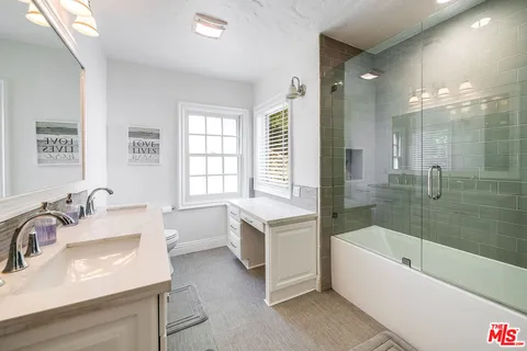 a view of a swimming pool with lawn chairs under an umbrella