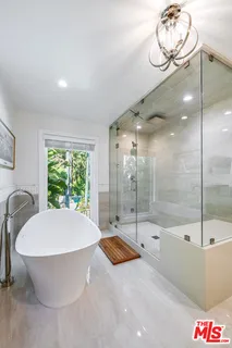 a view of backyard with swimming pool and sitting area