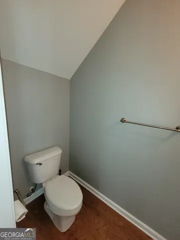 a white toilet sitting next to a small bathroom