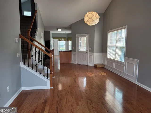 a view of an entryway with wooden floor