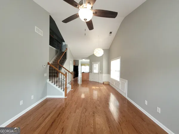 a view of entryway and hall with wooden floor