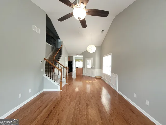 a view of entryway and hall with wooden floor