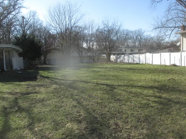 a big yard with lots of green space and trees