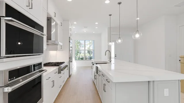 a kitchen with counter top space appliances and cabinets