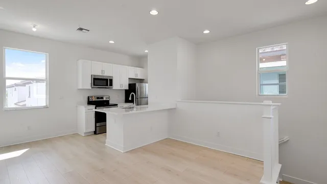 a view of a kitchen with an oven and refrigerator