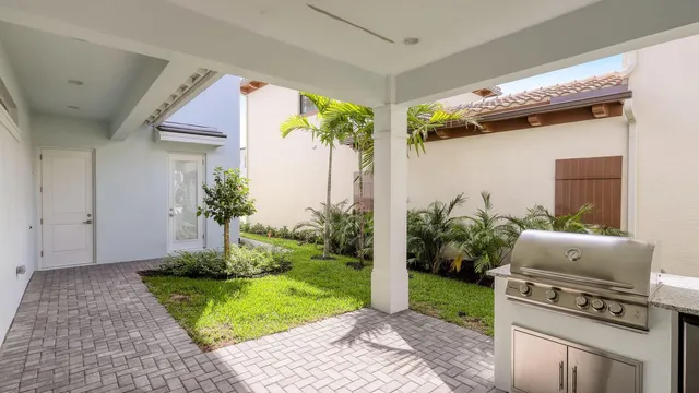 a backyard of a house with plants and outdoor seating