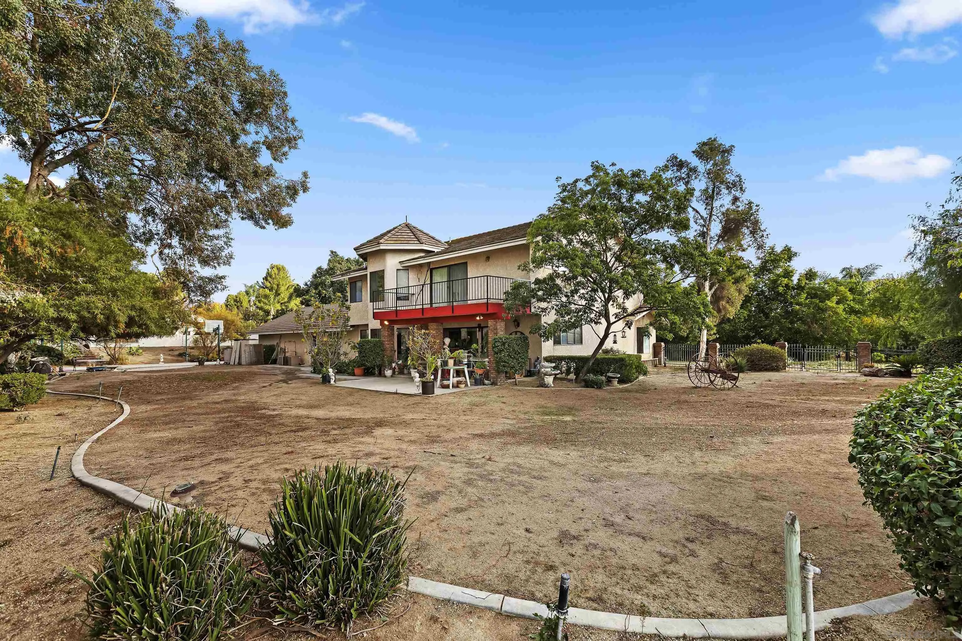 2109 Old Bridge Road Riverside, CA 92506 - Photo 46 of 57 a front view of a house with a yard and a large tree