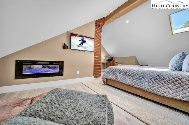 a bedroom with a bed and a painting on the wall