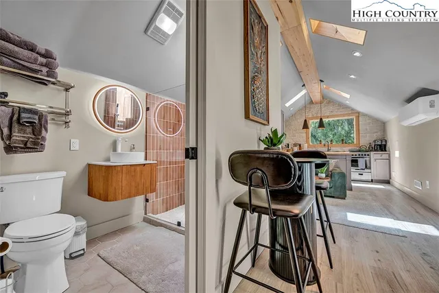 a bathroom with a toilet a sink and a mirror