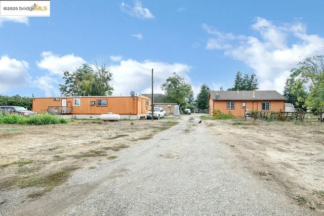 a backyard of a house with outdoor seating