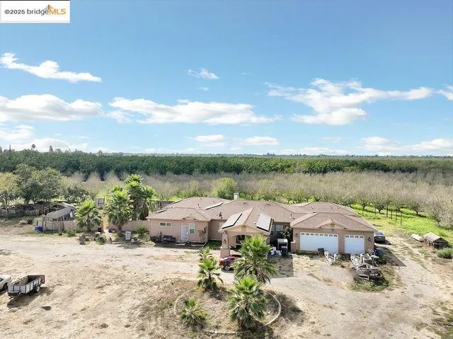 a view of a hallway with dining area and glass windows