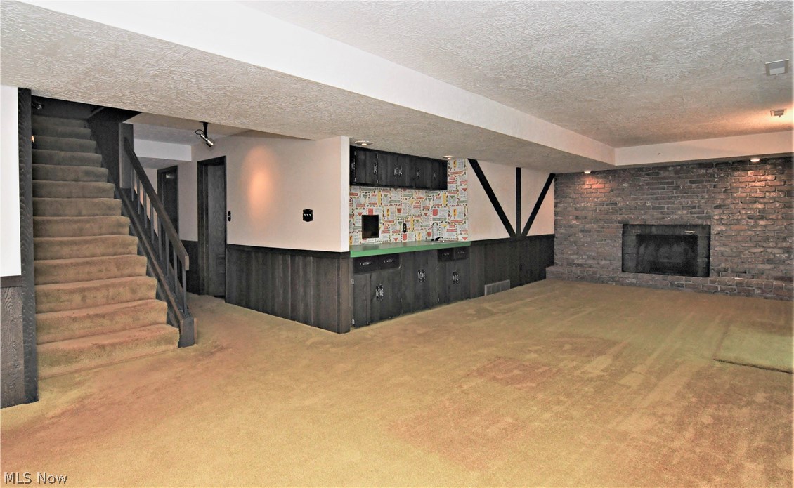 1271 Sand Run Road Akron, OH 44313 - Photo 20 of 32 walk out lower level family with fireplace and bar area, half bath is off the fam rm area, full wall of sliders
