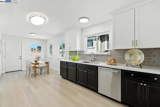 a kitchen with a sink stove top oven and microwave