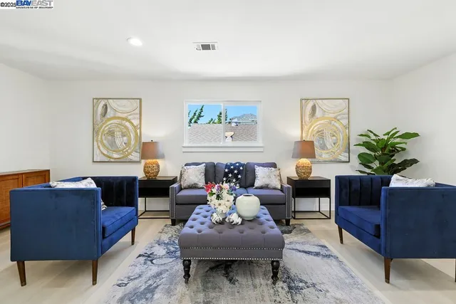 a living room with furniture and a potted plant